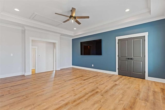 interior space with a raised ceiling and baseboards