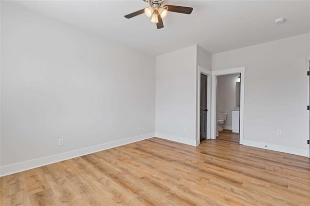 spare room with light wood-style floors, baseboards, and a ceiling fan