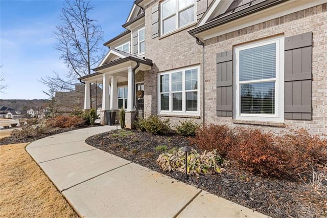 entrance to property featuring brick siding