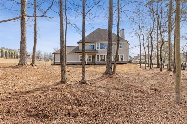 view of front of property featuring a chimney and fence