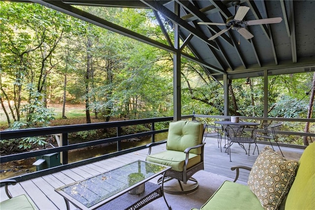 sunroom featuring lofted ceiling and ceiling fan