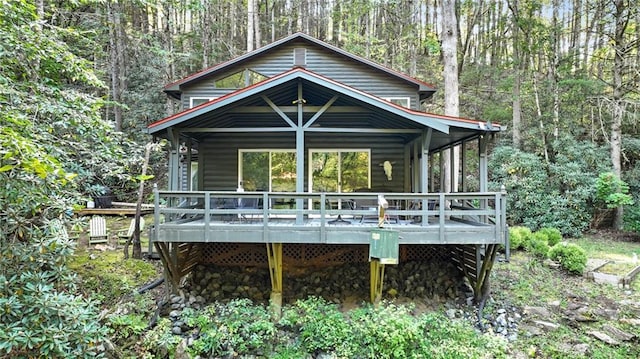 rear view of property with a wooden deck