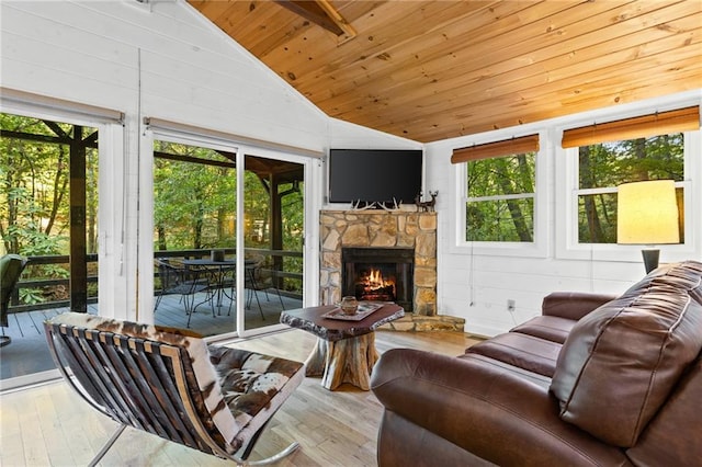 living room with high vaulted ceiling, light wood-type flooring, wood ceiling, and a stone fireplace