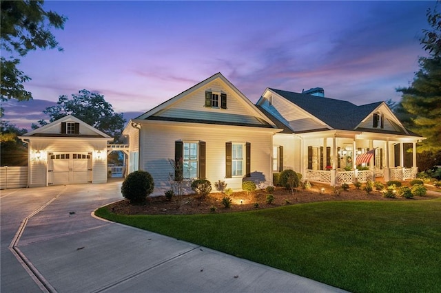 craftsman house featuring driveway, a garage, a yard, an outdoor structure, and a porch