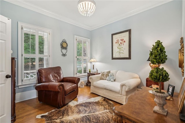 living area featuring ornamental molding, a wealth of natural light, and wood finished floors