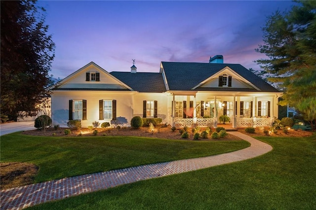 view of front of home featuring covered porch and a front yard