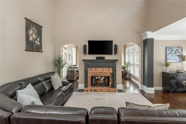 107 Estates At The Lake Dr, Canton, GA 30114 - living room with baseboards, arched walkways, wood finished floors, and a fireplace