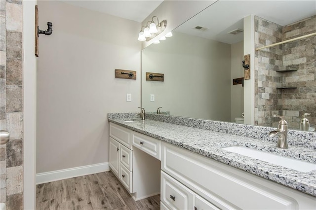 107 Estates At The Lake Dr, Canton, GA 30114 - bathroom featuring a tile shower, wood finished floors, a sink, and visible vents