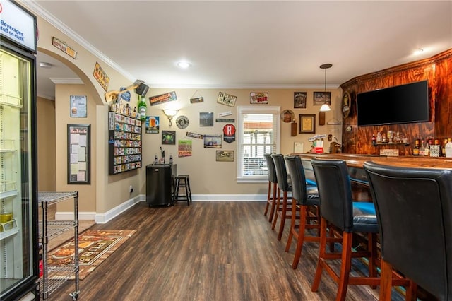 107 Estates At The Lake Dr, Canton, GA 30114 - bar with crown molding, arched walkways, wet bar, wood finished floors, and baseboards