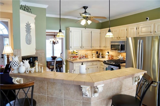 kitchen with a kitchen bar, crown molding, appliances with stainless steel finishes, and a sink