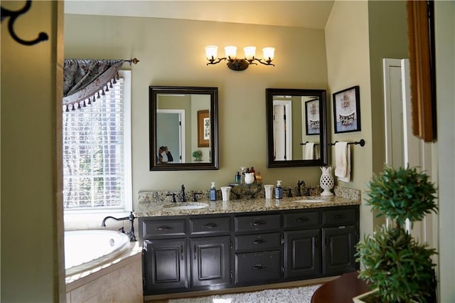 full bathroom with double vanity, a garden tub, and a sink