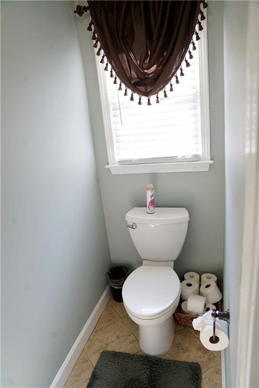 bathroom featuring tile patterned floors, toilet, and baseboards