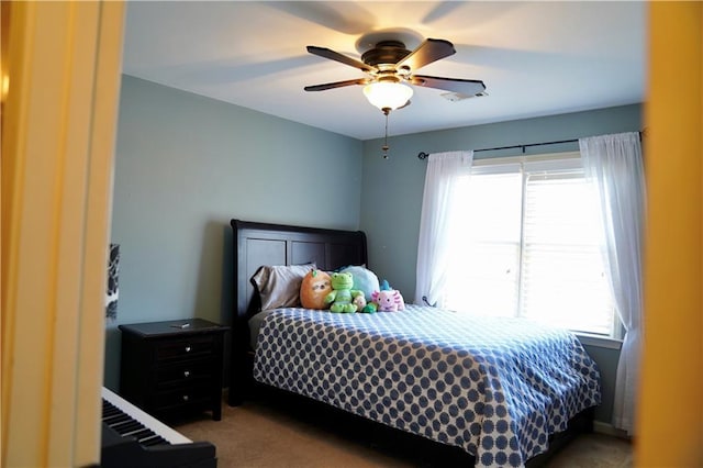 carpeted bedroom featuring multiple windows and a ceiling fan