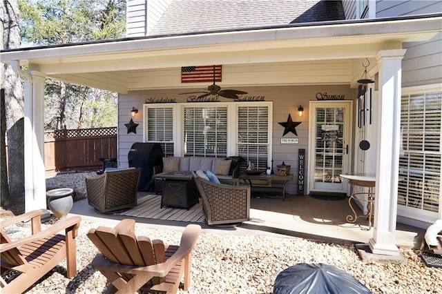 view of patio with outdoor lounge area, area for grilling, fence, and ceiling fan