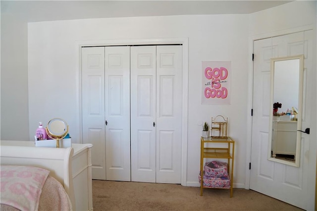 bedroom featuring a closet and light carpet