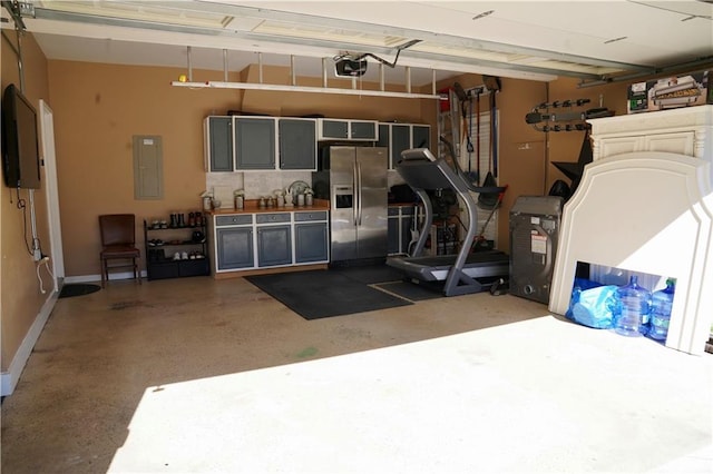 garage featuring electric panel, baseboards, stainless steel fridge, and a garage door opener