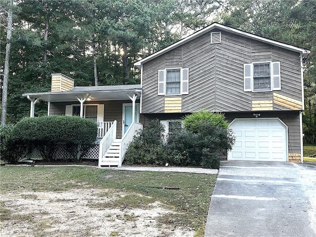 split level home with a porch and a garage