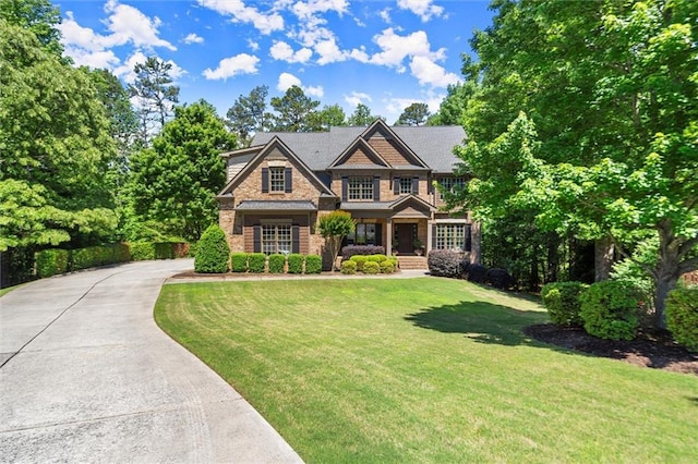 2660 Burnt Hickory Dr, Cumming, GA 30028 - craftsman house with a front yard, stone siding, covered porch, and concrete driveway