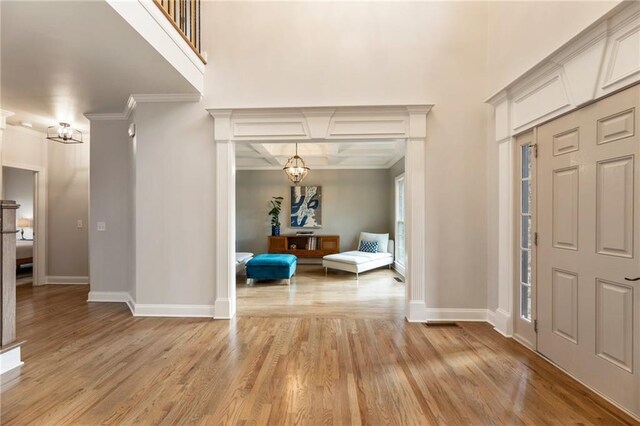 2660 Burnt Hickory Dr, Cumming, GA 30028 - entrance foyer with a chandelier, crown molding, baseboards, light wood finished floors, and coffered ceiling