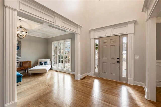 2660 Burnt Hickory Dr, Cumming, GA 30028 - foyer entrance with a chandelier, light wood finished floors, baseboards, and ornamental molding