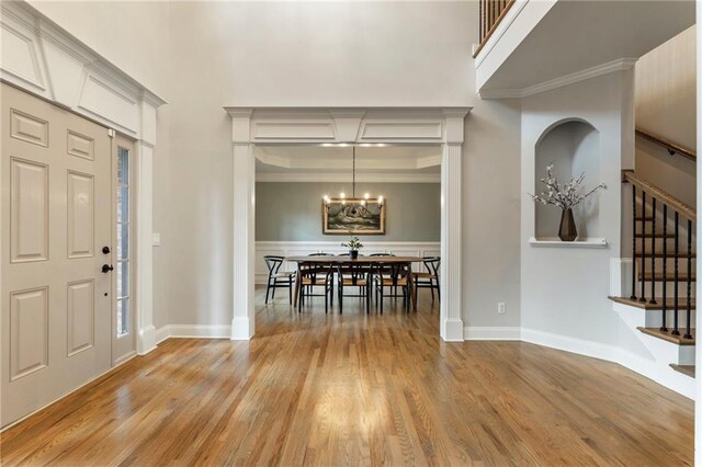 2660 Burnt Hickory Dr, Cumming, GA 30028 - entryway with light wood finished floors, stairs, a chandelier, ornamental molding, and baseboards