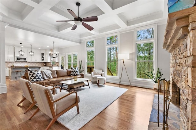 2660 Burnt Hickory Dr, Cumming, GA 30028 - living area featuring wood finished floors, a ceiling fan, a fireplace, beam ceiling, and a chandelier