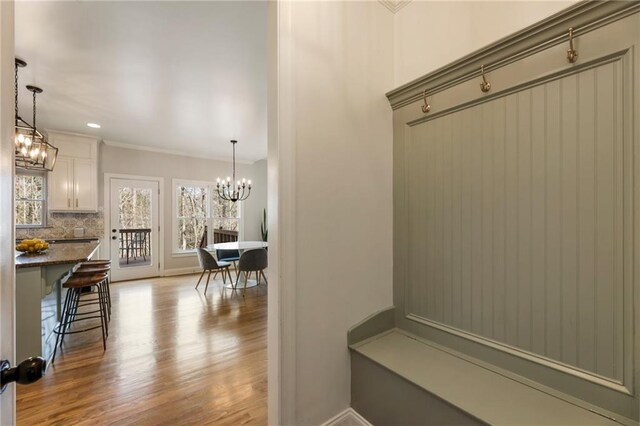 2660 Burnt Hickory Dr, Cumming, GA 30028 - mudroom with wood finished floors, a chandelier, and ornamental molding