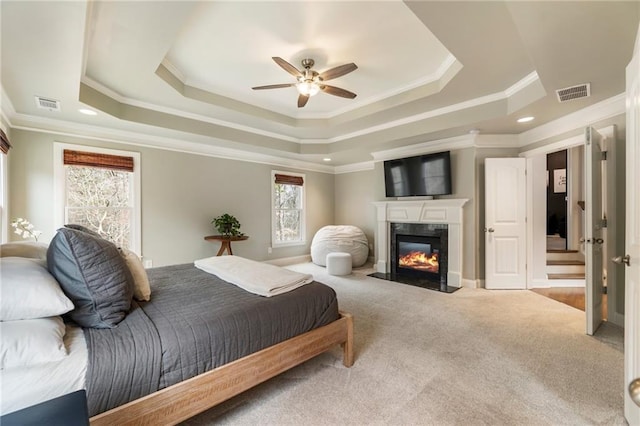 2660 Burnt Hickory Dr, Cumming, GA 30028 - carpeted bedroom with a raised ceiling, ornamental molding, a fireplace, and ceiling fan