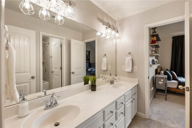 2660 Burnt Hickory Dr, Cumming, GA 30028 - ensuite bathroom featuring double vanity, tile patterned flooring, and baseboards