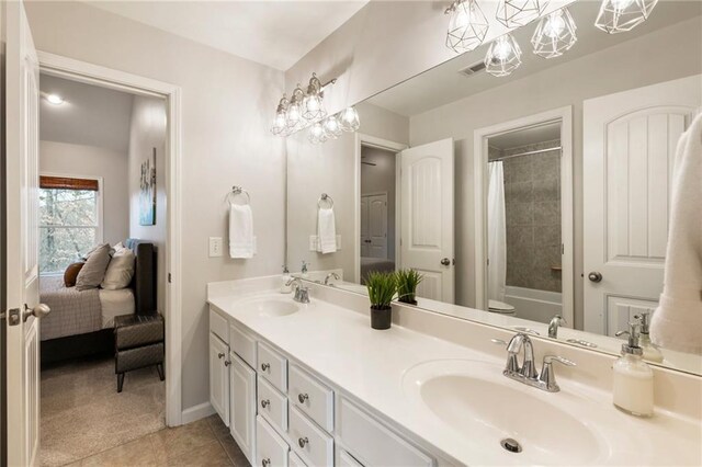 2660 Burnt Hickory Dr, Cumming, GA 30028 - bathroom featuring double vanity, tile patterned flooring, baseboards, shower / bathtub combination with curtain, and toilet