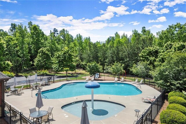 2660 Burnt Hickory Dr, Cumming, GA 30028 - community pool with fence, a patio area, and view of scattered trees