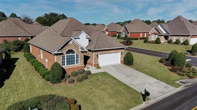 view of front of house featuring a front lawn and a garage