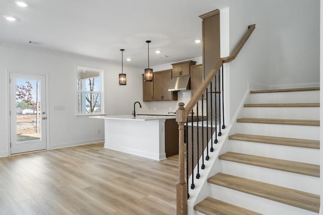 interior space featuring baseboards, wood finished floors, and recessed lighting