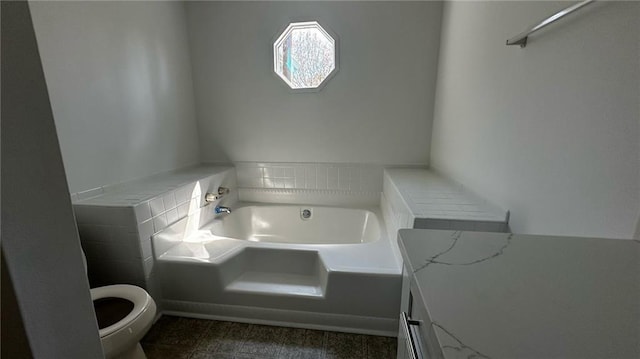 bathroom featuring toilet and a garden tub