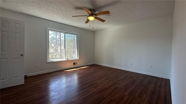 empty room with visible vents, a textured ceiling, baseboards, ceiling fan, and dark wood-style flooring