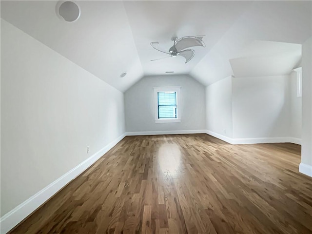 bonus room with baseboards, ceiling fan, wood finished floors, and vaulted ceiling