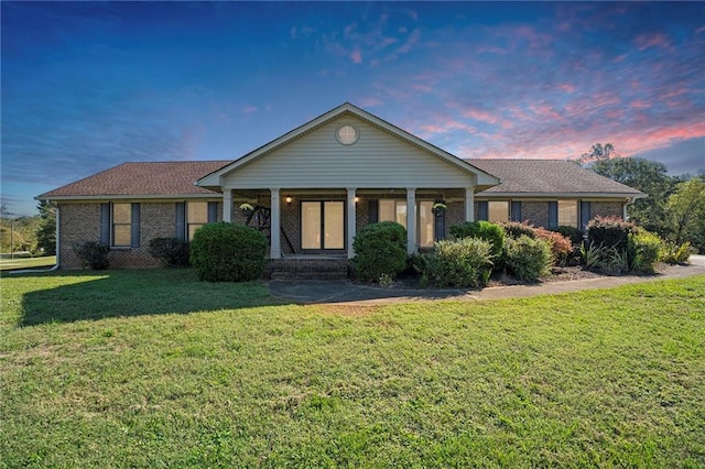 ranch-style home with a lawn