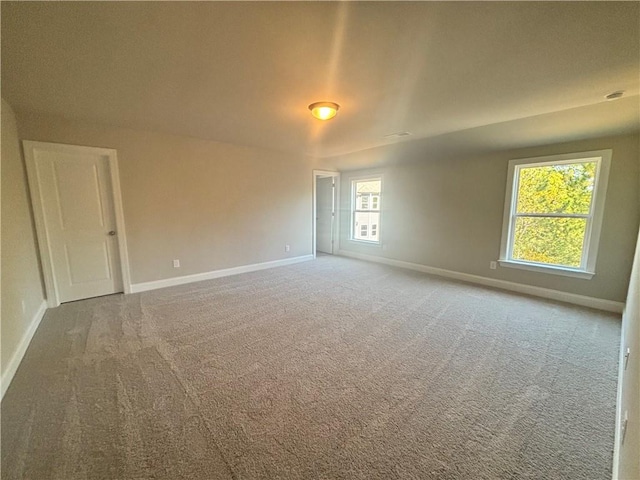 carpeted spare room with a healthy amount of sunlight