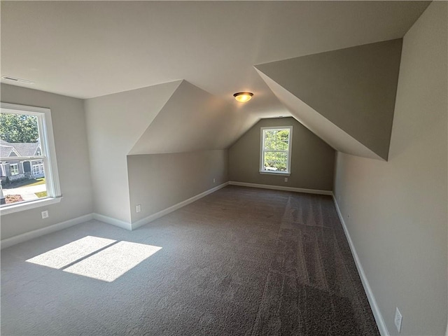 bonus room featuring dark carpet and lofted ceiling