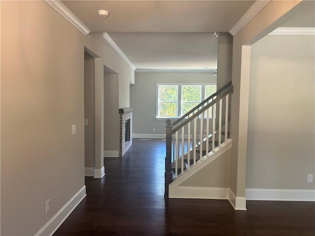 interior space with ceiling fan, crown molding, a fireplace, and hardwood / wood-style floors