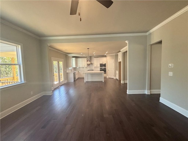 unfurnished living room featuring ceiling fan, ornamental molding, and dark hardwood / wood-style floors