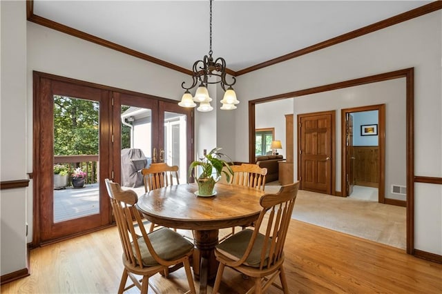 3525 Stone Cliff Way, Woodstock, GA 30189 - dining space with healthy amount of natural light, a chandelier, baseboards, ornamental molding, and french doors
