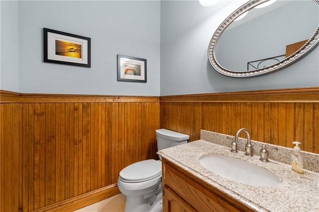 3525 Stone Cliff Way, Woodstock, GA 30189 - bathroom featuring a wainscoted wall, toilet, vanity, and wooden walls