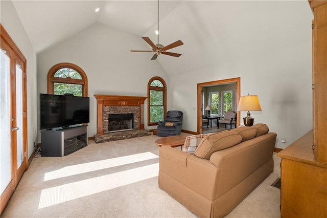 3525 Stone Cliff Way, Woodstock, GA 30189 - living area with light colored carpet, a stone fireplace, plenty of natural light, high vaulted ceiling, and a ceiling fan