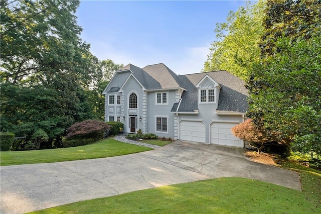 3525 Stone Cliff Way, Woodstock, GA 30189 - colonial home featuring concrete driveway, a front lawn, a garage, and roof with shingles