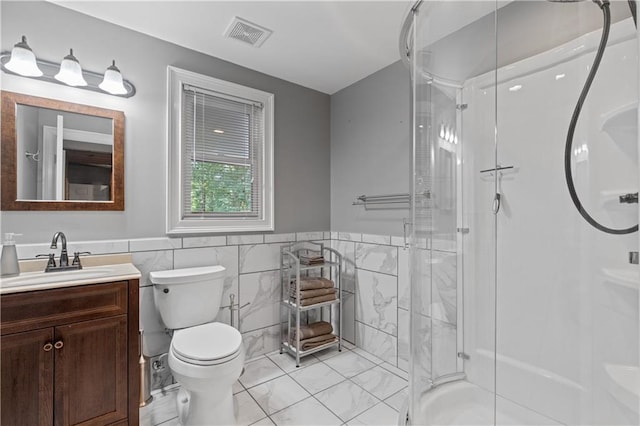 3525 Stone Cliff Way, Woodstock, GA 30189 - bathroom featuring vanity, a shower stall, tile walls, toilet, and a wainscoted wall
