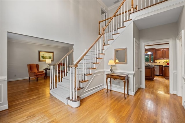 3525 Stone Cliff Way, Woodstock, GA 30189 - staircase featuring a towering ceiling, wood finished floors, and ornamental molding