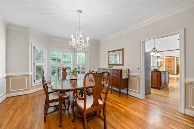 3525 Stone Cliff Way, Woodstock, GA 30189 - dining area featuring a chandelier, light wood finished floors, ornamental molding, wainscoting, and a decorative wall