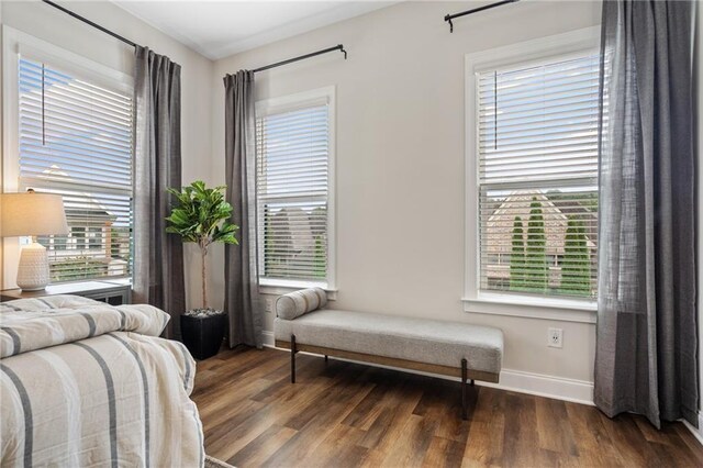 bedroom featuring baseboards and wood finished floors