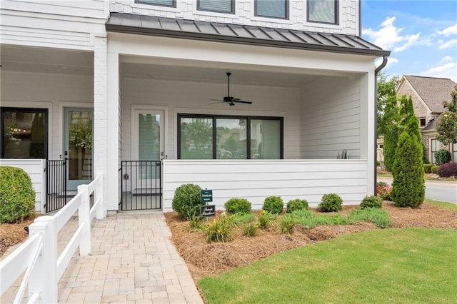 property entrance featuring a standing seam roof, ceiling fan, and metal roof
